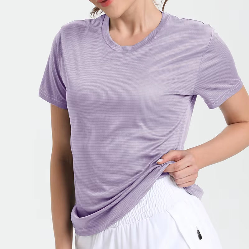 Lavender women's ultralight quick-dry sport T-shirt, breathable compression top worn with white shorts.
