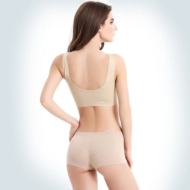 Back view of a woman in a padless beige wireless sports bra and matching boyshorts.