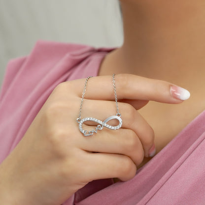 Infinity Love pendant necklace with a rhinestone-encrusted loop and Love script on a silver chain.