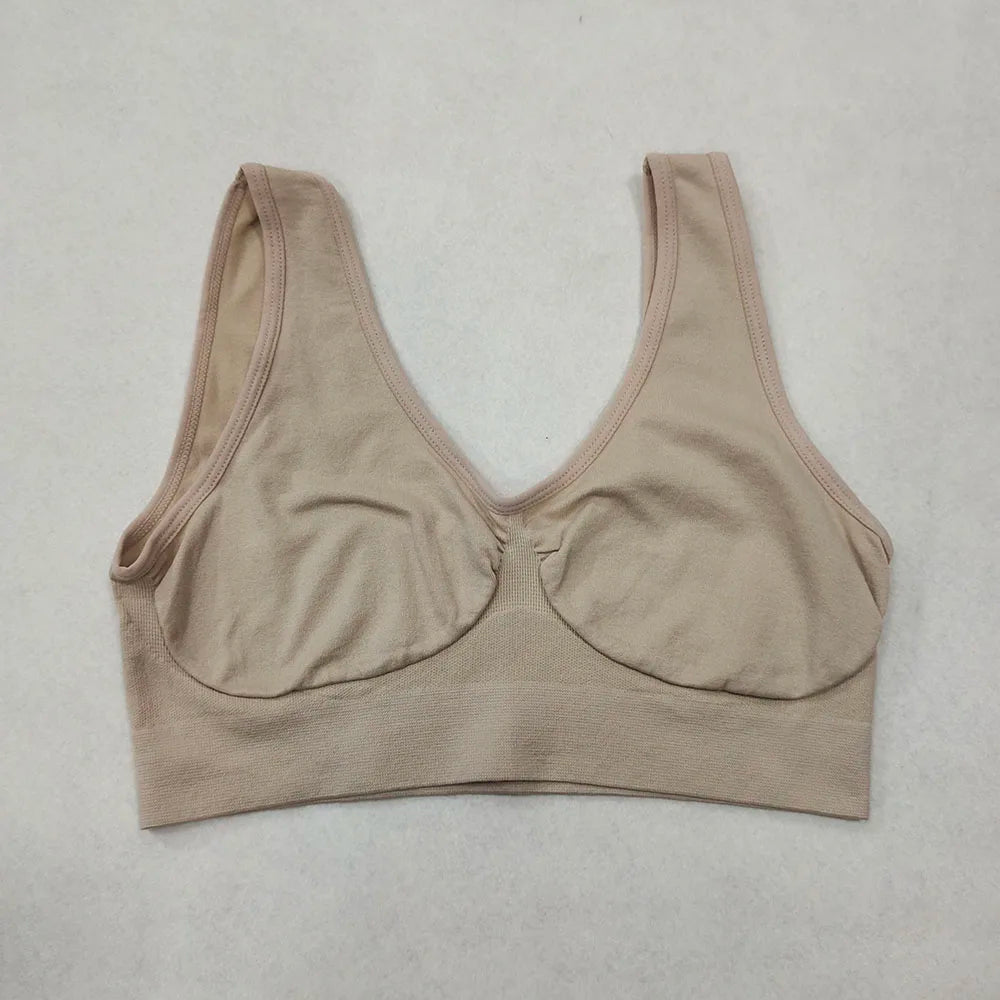 Beige wireless bralette with wide non-adjustable straps, no padding, seamless underband.