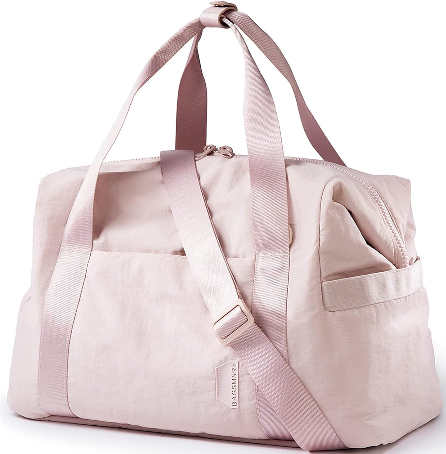 Pink nylon gym bag with dual carry handles, adjustable shoulder strap, compact weekender duffel with side pocket.